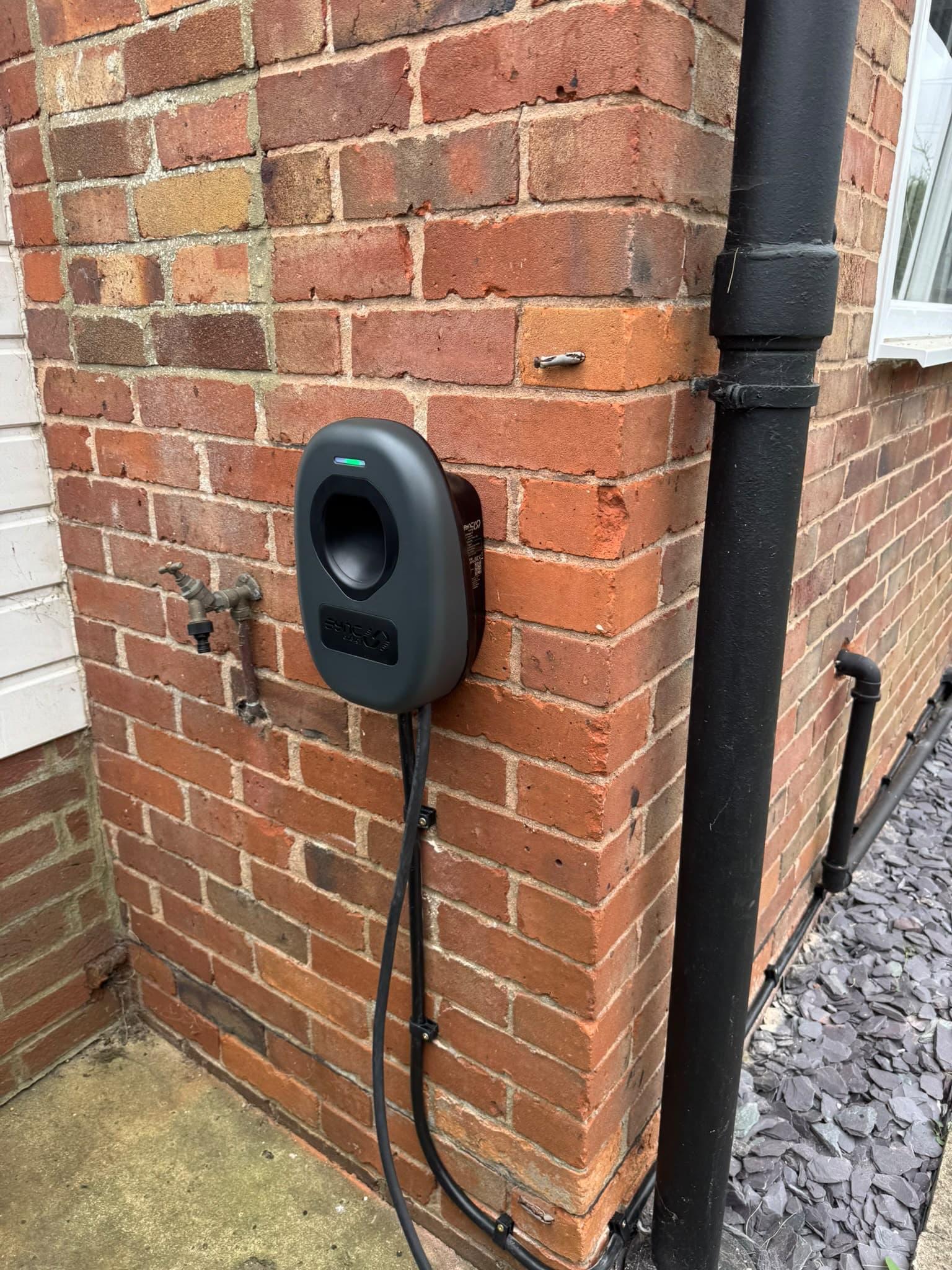 Evans All Electrical ev charger wall mounted on brick corner