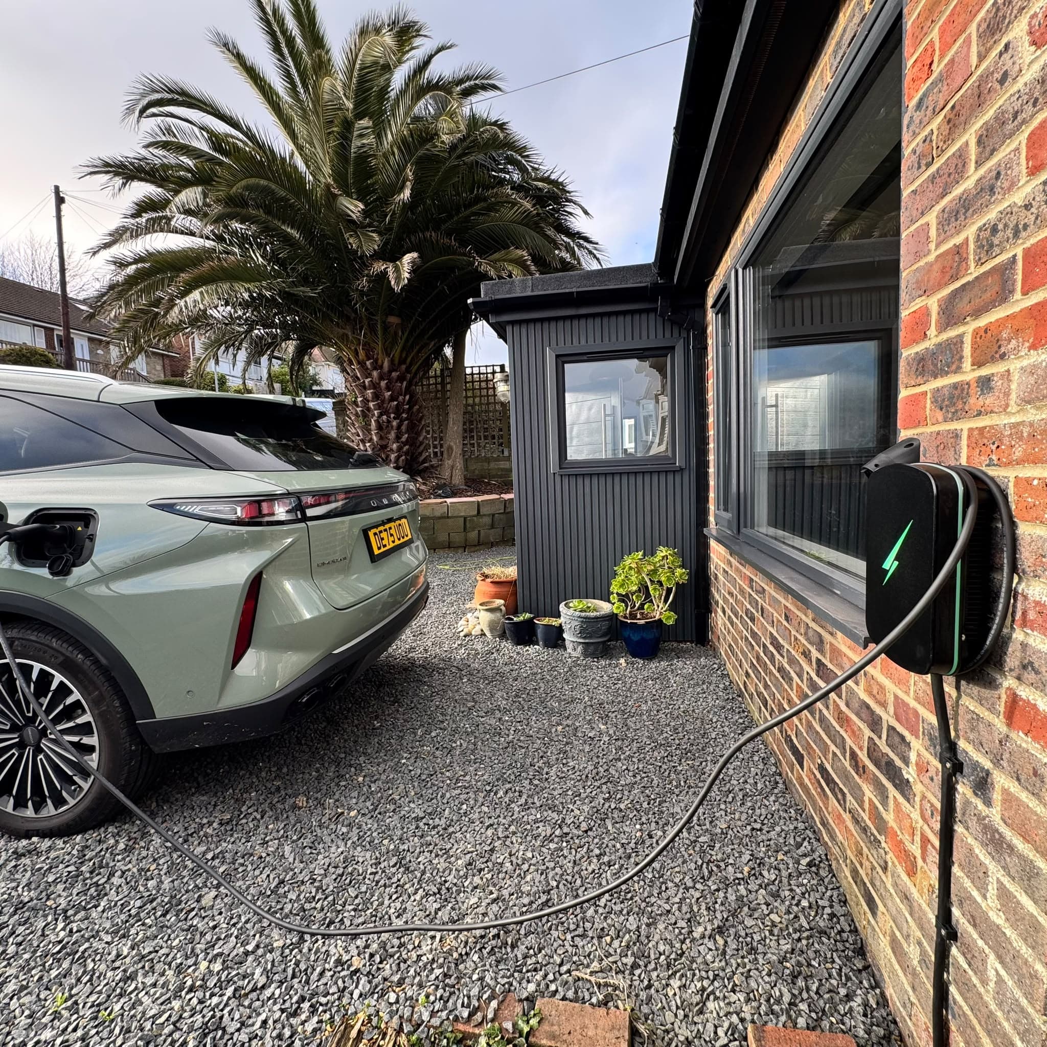 Evans All Electrical EV charger with electric car on gravel drive